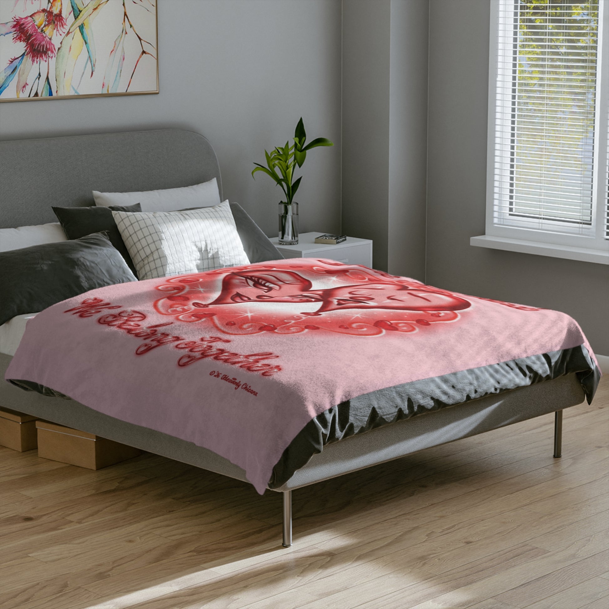 Bedroom with a pink blanket featuring a red heart design and text.