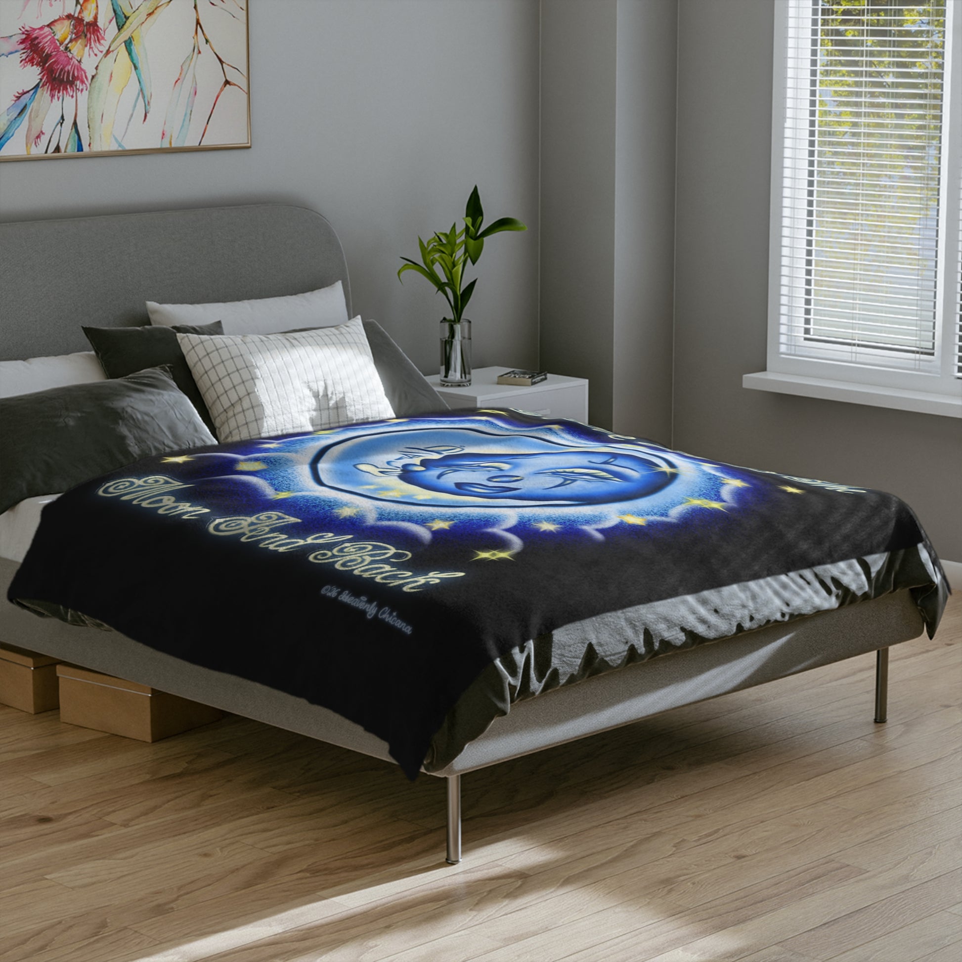 Bedroom with a bed featuring a blue and black blanket with a spiral design.