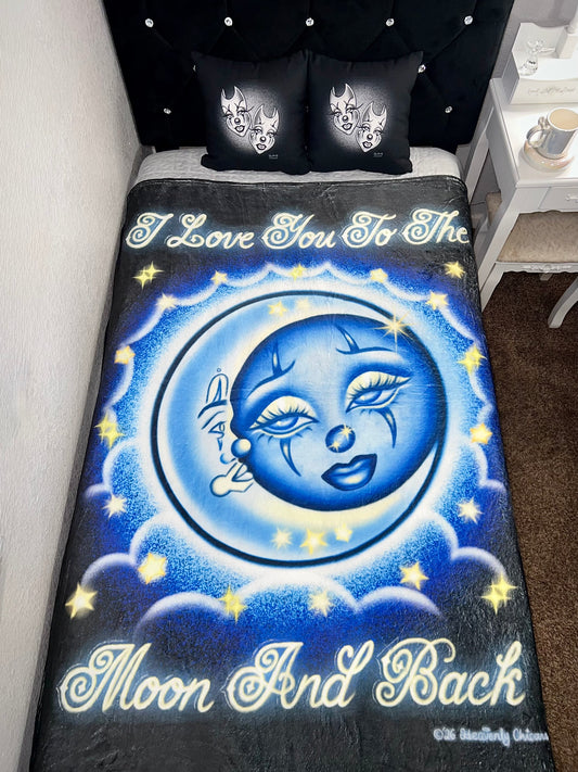 Blanket with celestial design and text on a bed