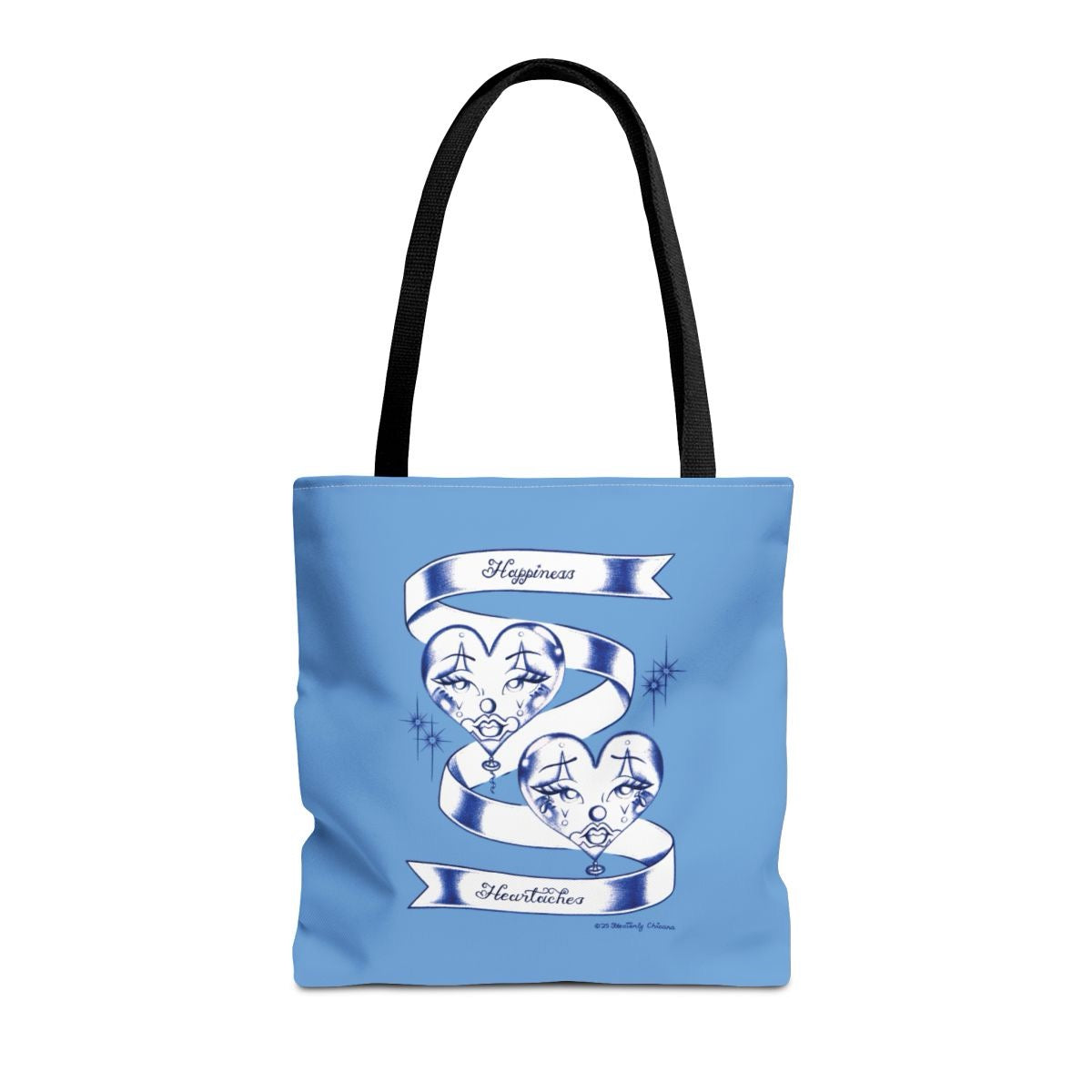 Blue tote bag with a graphic design of two faces in hearts and text on a white background